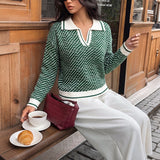 Green patterned V-neck sweater with white ribbed hem and cuffs, long sleeves.