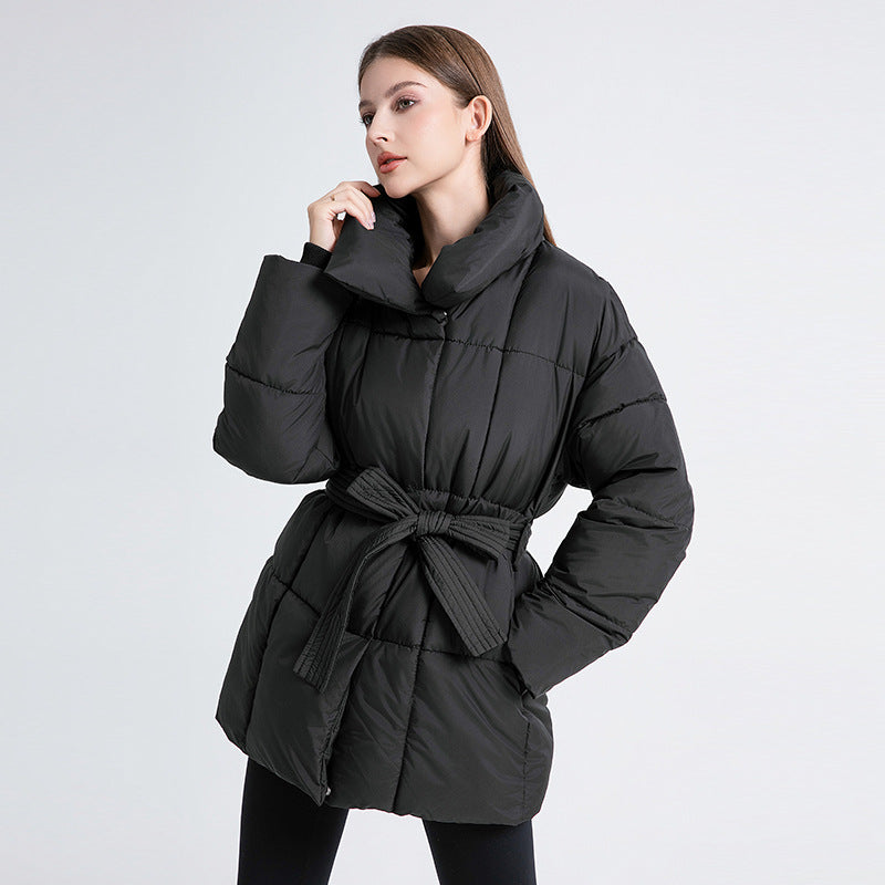 Women's tailored quilted puffer coat in black with tie belt and high shawl collar