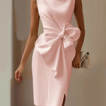 Pink satin sleeveless dress with draped waist and large bow detail