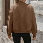 Oversized brown bomber jacket back view with long sleeves and ribbed cuffs
