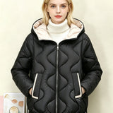 Black quilted short jacket with hood, heart stitching, central zip front and side pocket openings.