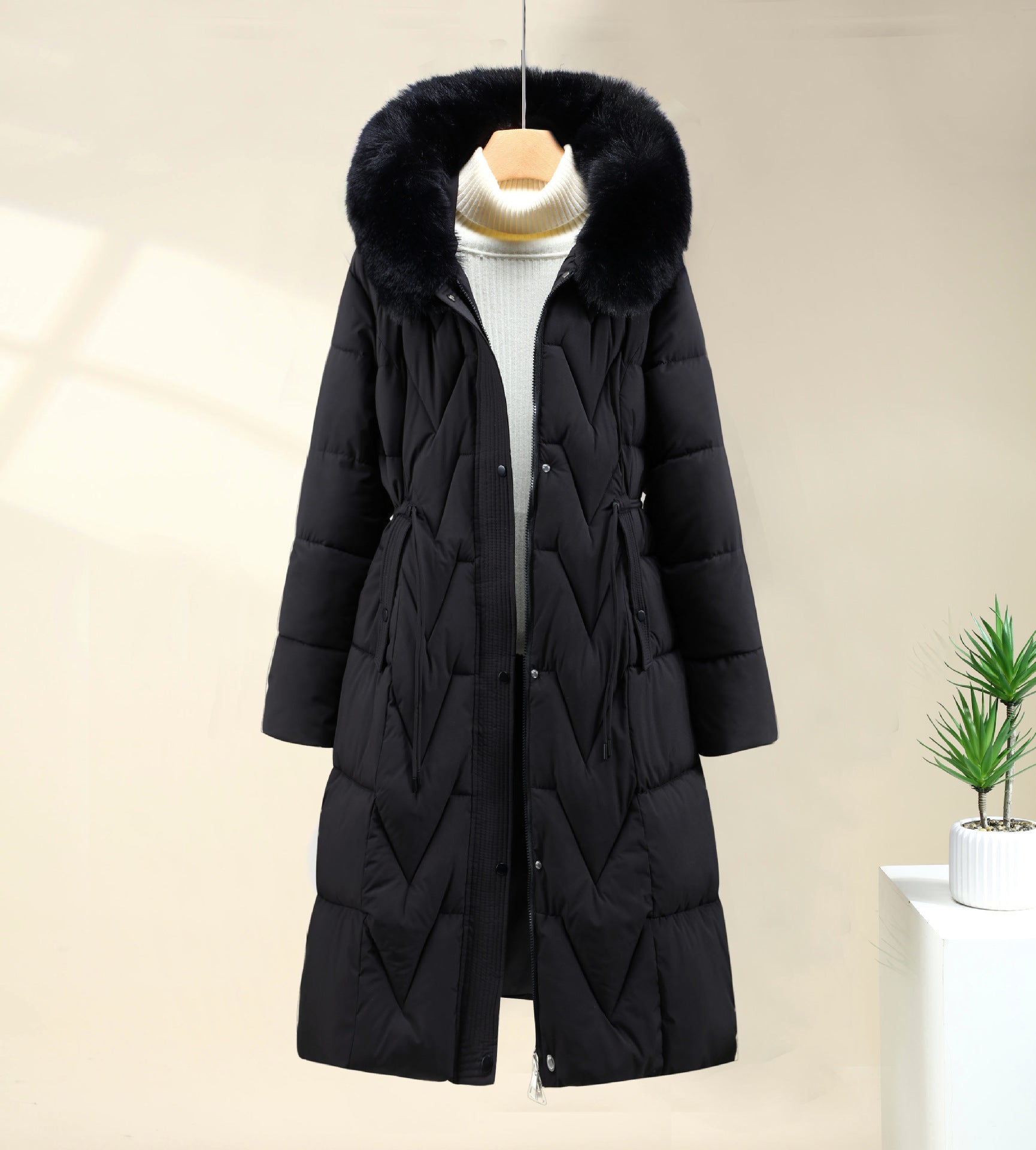 Long black parka with faux-fur hood and drawstring waist, front button closure