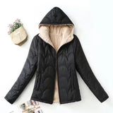 Women's black quilted hooded jacket with beige sherpa lining, zipper, and pockets