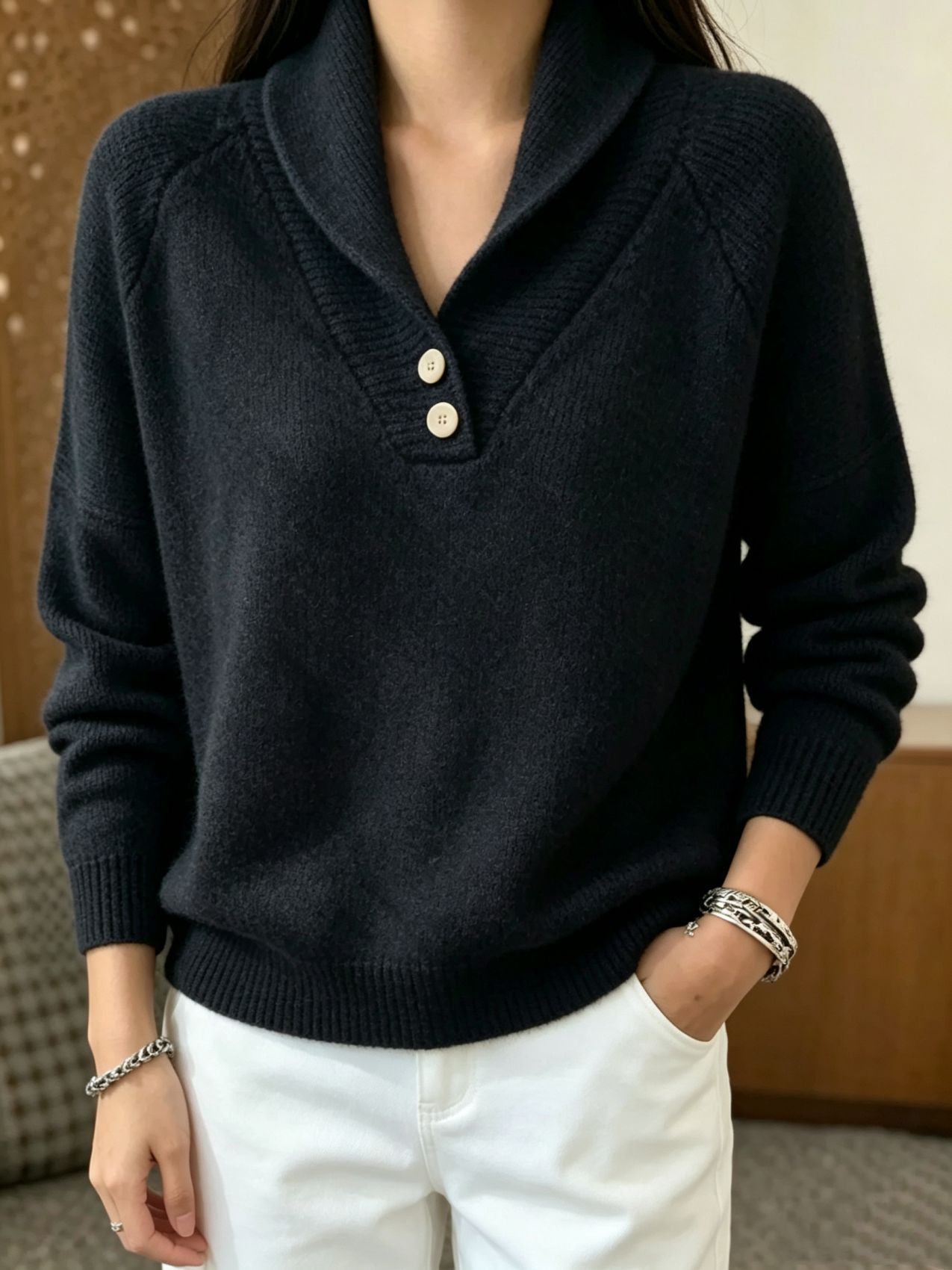 Women’s black button-front V-neck long-sleeve sweater with ribbed collar and hem.