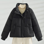 Black short quilted jacket with stand collar, front zipper, and two flap pockets