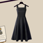 Fishtail style sleeveless dress with pleated A-line skirt, dark color