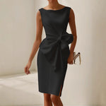 Black satin sleeveless dress with draped waist and oversized bow