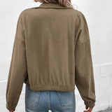 Cropped long-sleeve jacket back view in olive textured fabric with full button placket.
