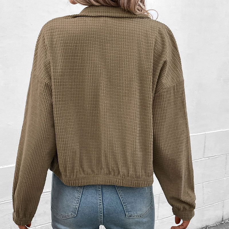 Cropped long-sleeve jacket back view in olive textured fabric with full button placket.