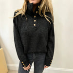 Black long-sleeve knit pullover with button placket and stand collar, ribbed cuffs