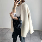 Cream button-front knit cardigan with long sleeves and open front