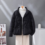 Women's short quilted jacket in black, high collar, zip front, flap pockets.