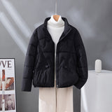Women's short quilted jacket in black, high collar, zip front, flap pockets.