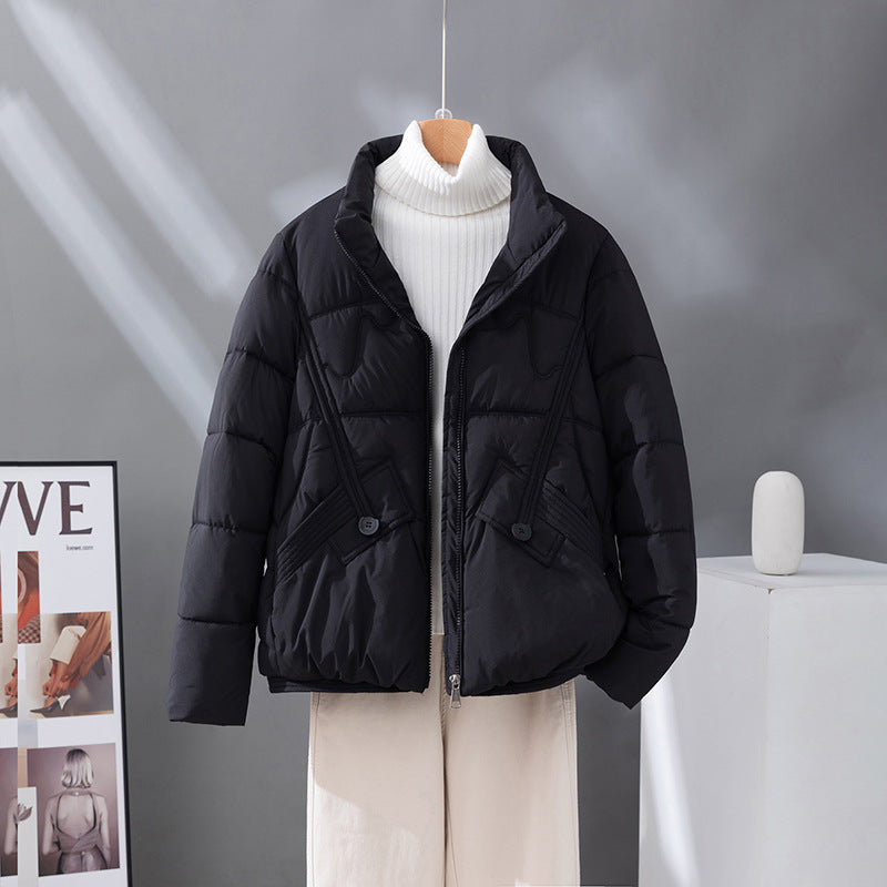 Women's short quilted jacket in black, high collar, zip front, flap pockets.