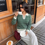 Green V-neck long-sleeve sweater with white ribbed trim at collar, cuffs, hem.