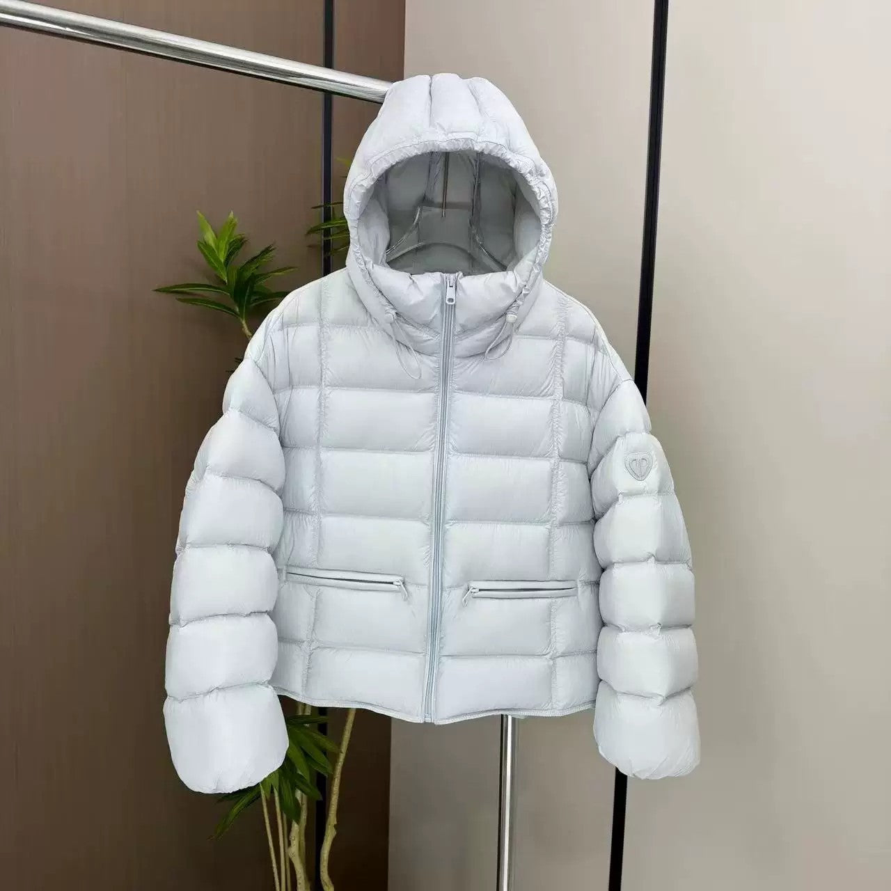 Short padded hooded thermal jacket in white with full-zip front and side zip pockets