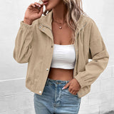 Cropped long-sleeve jacket in beige textured fabric, open front with snap buttons and pockets.