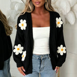 Oversized black long-sleeve cardigan with white daisy appliqués