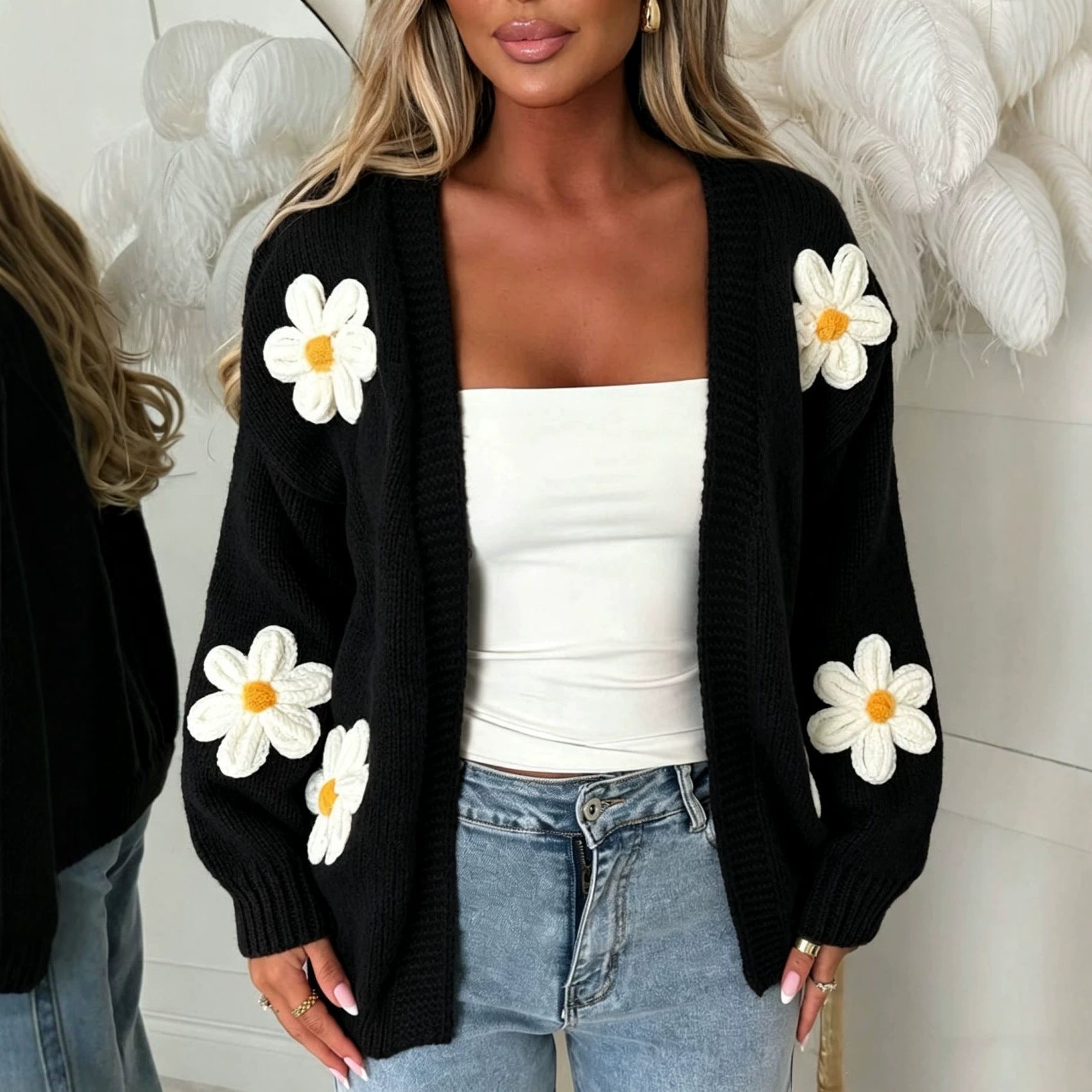 Oversized black long-sleeve cardigan with white daisy appliqués