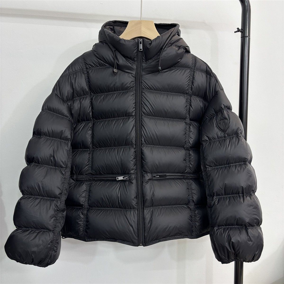 Short padded hooded thermal jacket in black with full-zip front and side zip pockets
