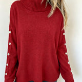 Oversized red long-sleeve turtleneck sweater with buttoned sleeve cuffs