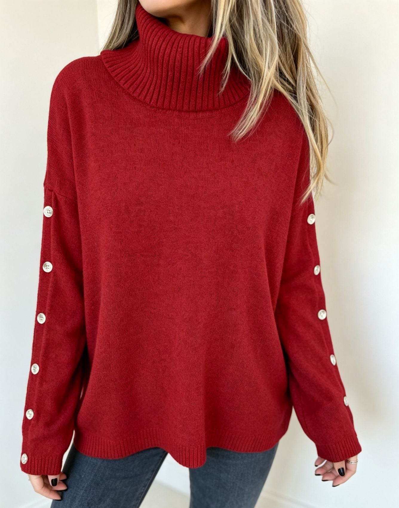 Oversized red long-sleeve turtleneck sweater with buttoned sleeve cuffs