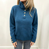 Blue long-sleeve knit pullover with button placket and stand collar, ribbed sleeves