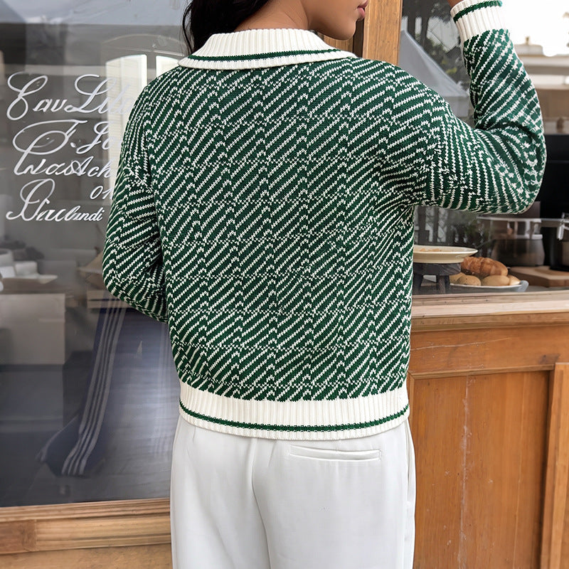 Green V-neck sweater back view with knit pattern and white ribbed waistband and cuffs.