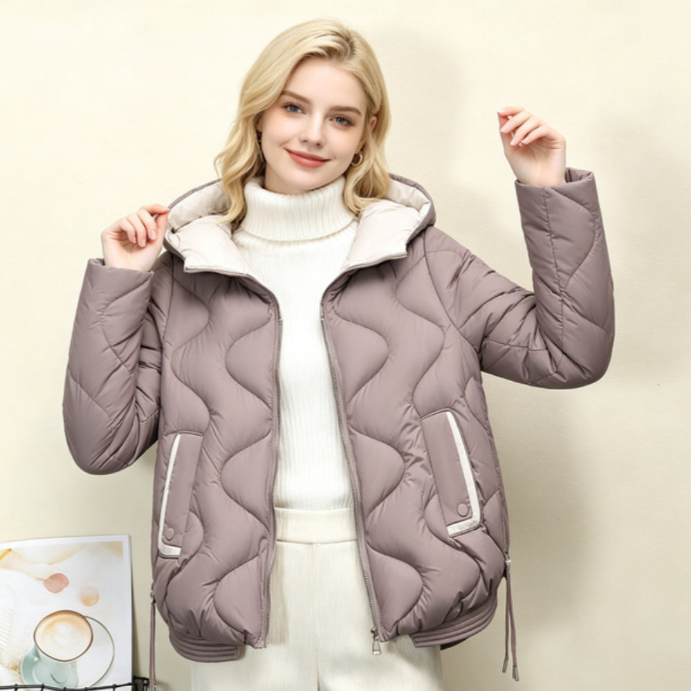 Light taupe quilted short jacket with hood, heart stitching, zip front and drawcord hem.
