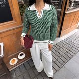 Green V-neck long-sleeve sweater with white ribbed trim and allover textured knit pattern.