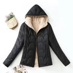 Women's black hooded quilted jacket with sherpa interior and long sleeves