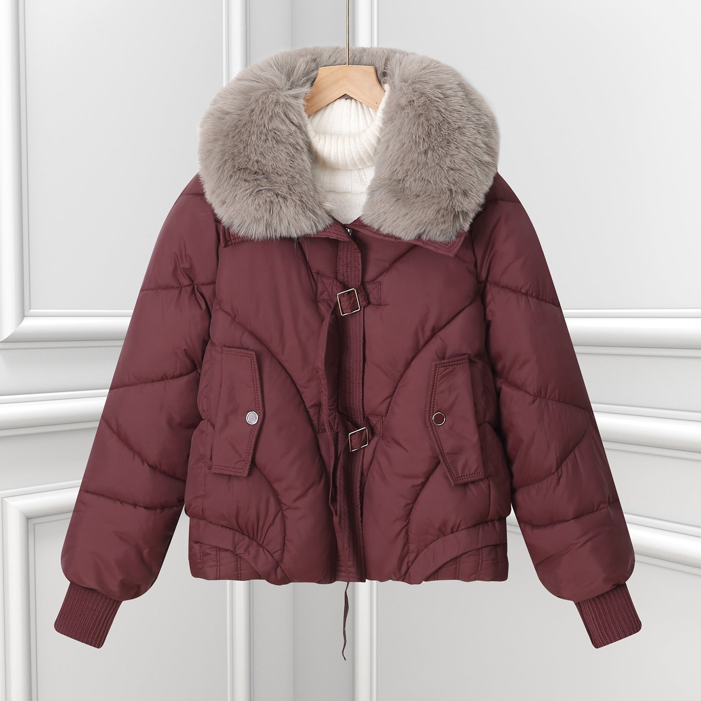 Burgundy short puffer pilot jacket with large faux fur collar and drawstring hem.
