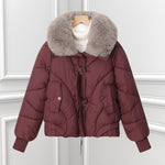 Burgundy short puffer pilot jacket with large faux fur collar and drawstring hem.
