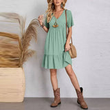 Green V-neck tiered midi dress with short sleeves, flowing tiered hem