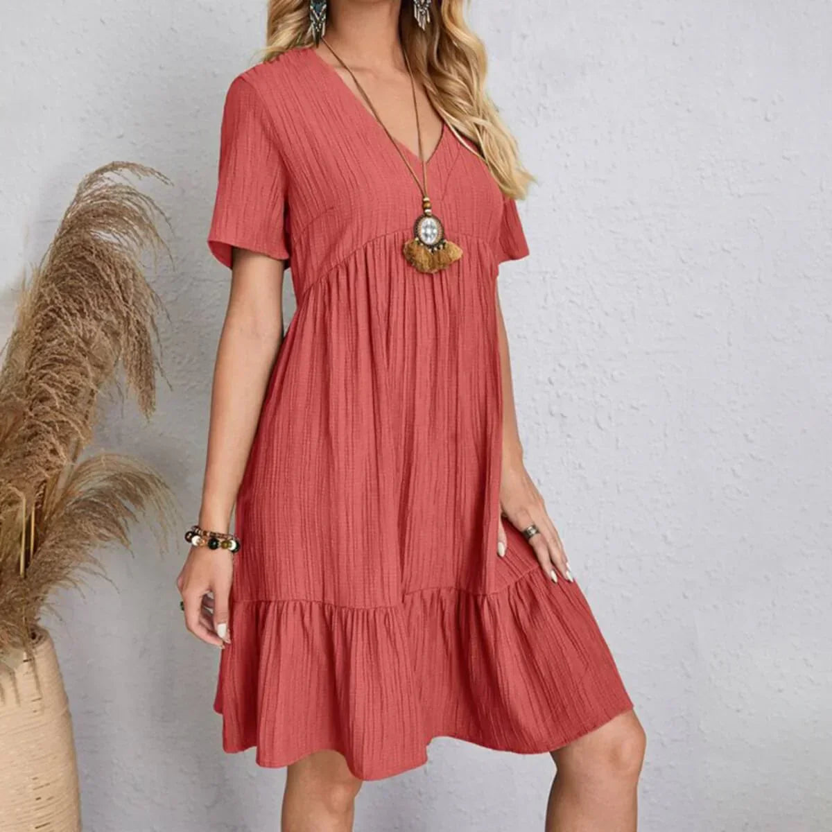 Coral V-neck tiered midi dress with short sleeves, soft draped tiers