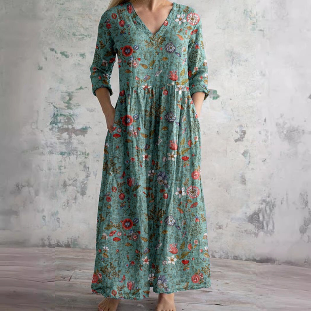 Floral long dress in teal with V-neck and three-quarter sleeves, gathered waist