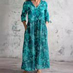 Floral long dress in teal with V-neck and three-quarter sleeves, gathered waist