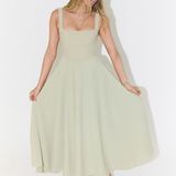 Sage green square-neck sleeveless midi dress, full skirt with gentle flare and pockets