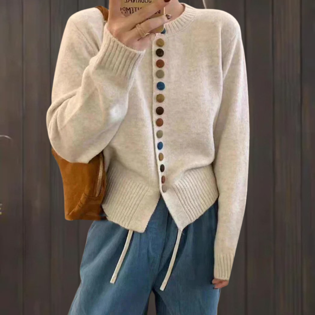 Cream knit cardigan with long sleeves and front button placket featuring multicolor buttons