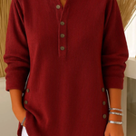 Red ribbed knit pullover with button-front placket and round neckline.