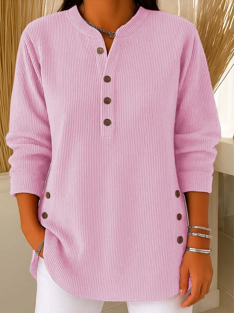 Pink ribbed knit pullover with button-front placket and round neckline.
