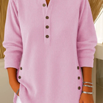 Pink ribbed knit pullover with button-front placket and round neckline.