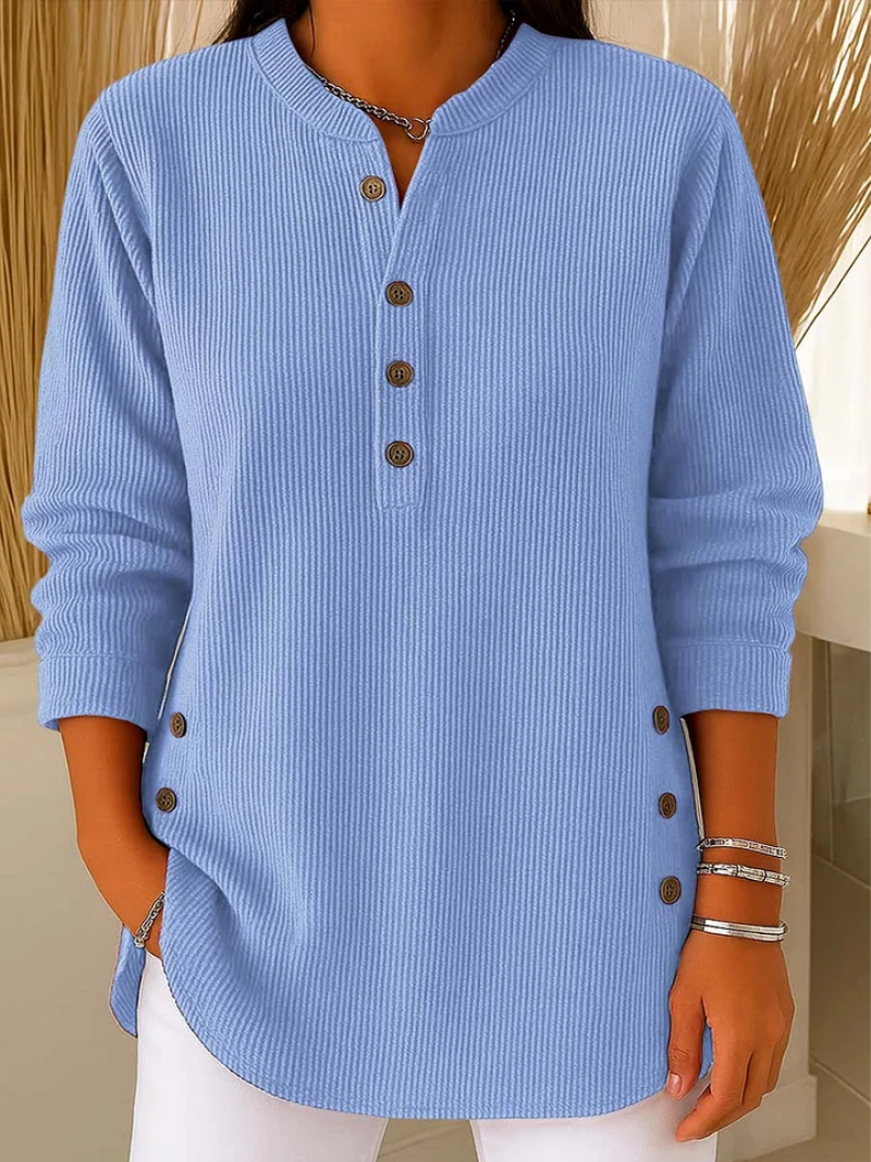 Blue ribbed knit pullover with button-front placket and round neckline.