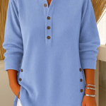Blue ribbed knit pullover with button-front placket and round neckline.
