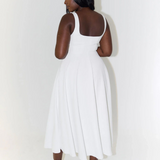 White midi dress back view, low square back, sleeveless straps, flared skirt