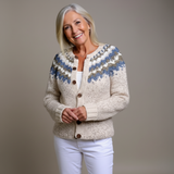 Cream chunky knit cardigan with blue patterned yoke and button-front, ribbed cuffs