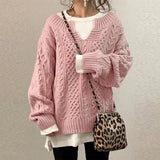 Pink cable-knit oversized sweater with V-neck, long sleeves, ribbed cuffs and hem
