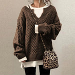 Brown cable-knit oversized sweater with V-neck, long sleeves, ribbed cuffs and hem