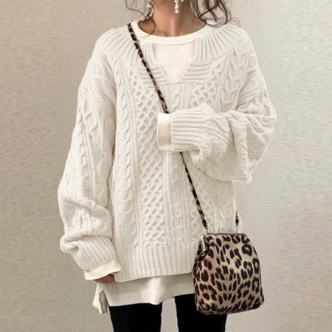 White cable-knit oversized sweater with V-neck, long sleeves, ribbed cuffs and hem