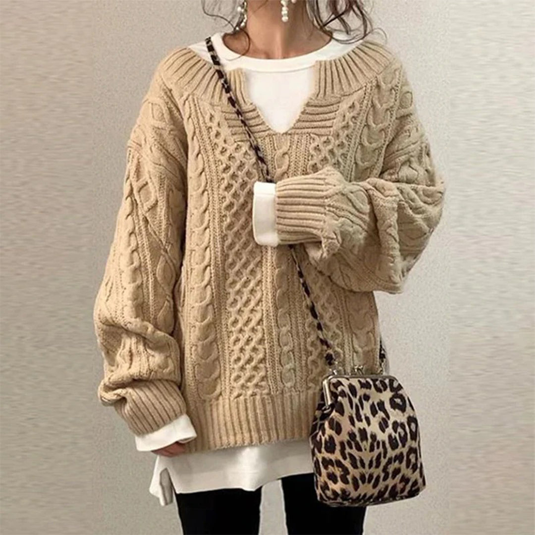 Beige cable-knit oversized sweater with V-neck, long sleeves, ribbed cuffs and hem